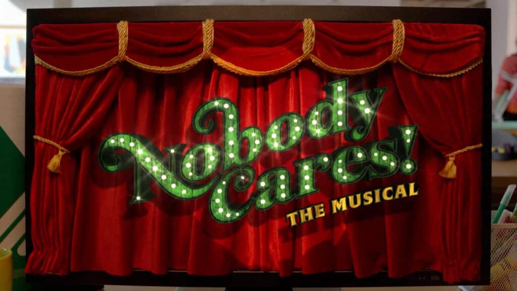 A red theater curtain with gold trim is framed by a sign reading “Nobody Cares! The Musical” in green illuminated letters, blending classic stage design with the flair of AI Art. AI Image made by Christian Fleischer / The Visiblemaker