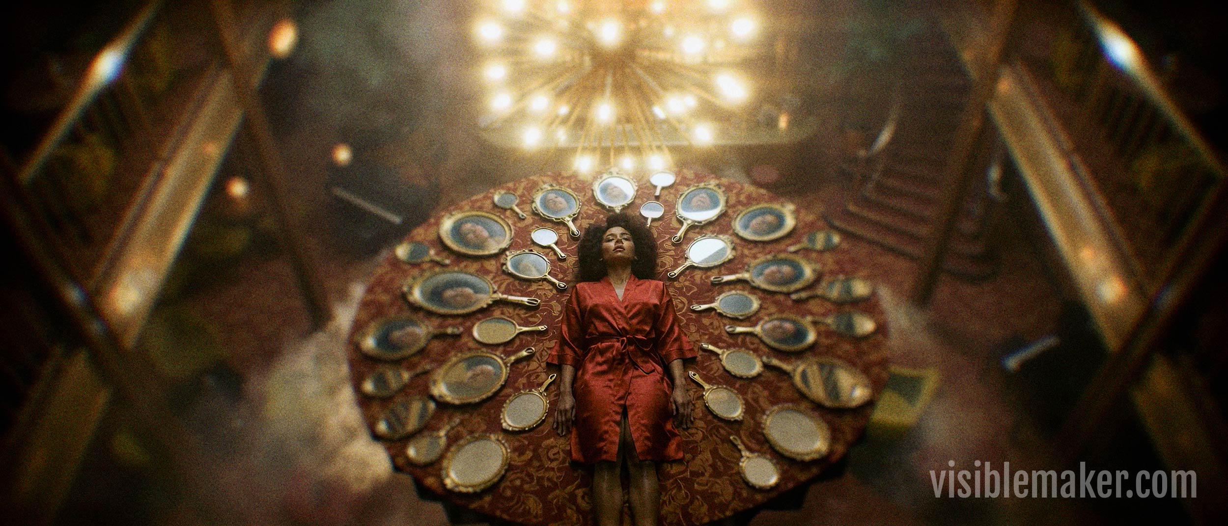 A woman in a red robe lies on her back with arms outstretched, surrounded by an ornate fan-like arrangement of mirrors. In this expressive ai scene, she is illuminated by a chandelier in a grand, dimly lit room with stairs on either side. AI Image made by Christian Fleischer / The Visiblemaker